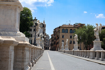 Fototapeta premium Pedestrian bridge full of statues, in front of the Castle of Sant'Angelo, also known as Hadrian's Castle, without people, a sunny day