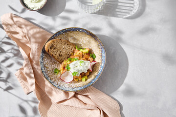 Salmon tartare with stracciatella and toast, bright natural lighting, overhead minimal composition