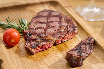 Ribeye steak sliced, grilled with sear marks, bright natural light, overhead clean wooden board...