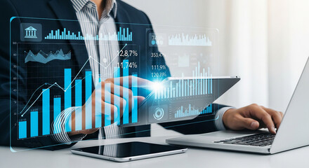 Businessman analyzing financial data on holographic interface with charts and graphs