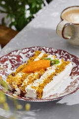 Carrot cake slice with cream cheese frosting, sunlit rustic atmosphere, overhead cafe table