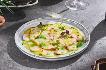 Scallop carpaccio in citrus sauce, bright lighting, overhead composition