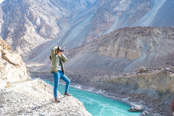 The tourist woman taking photo of beautiful Skardu valley in the Gilgit-Baltistan region of Pakistan