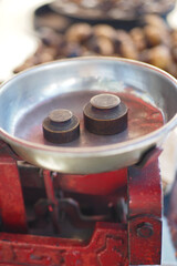 Old scale with weights on a market table in daytime