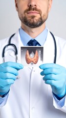 Doctor holding medical image of thyroid
