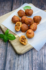 Mini cheese  burger balls.  Ball shaped snack with meat, pickled cucumbers and tomato on wooden background
