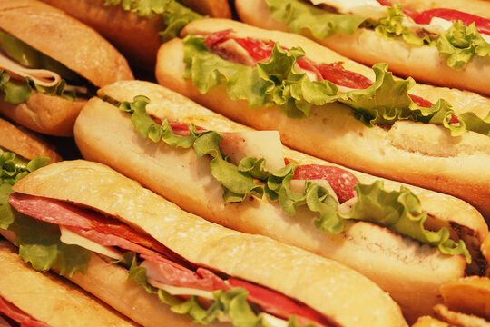Freshly made subs displayed at a deli counter for lunch
