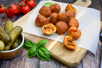 Mini cheese  burger balls.  Ball shaped snack with meat, pickled cucumbers and tomato on wooden background