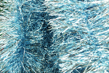 Blue Christmas background made of blue tinsel. New Year Festive background