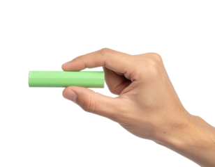 A hand holding a piece of green chalk against a black background.