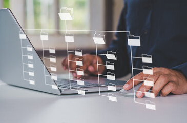 Systematic data storage for ease of use. Folder hierarchy structure and document management system DMS. Businessman using laptop computer for saving and classifying files.