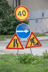 Road signs at the repair site on a summer day