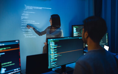 asian woman developers collaborating on a coding project, with one member presentation at code...