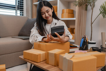 she in an entrepreneur, she sells product online, she own a small business that sell product online, sme, a lot of parcel stack in the room, working in her shopping online storage
