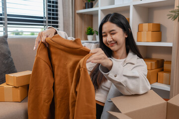 she is happily packing products into boxes to be sent to customers, an entrepreneur is preparing...
