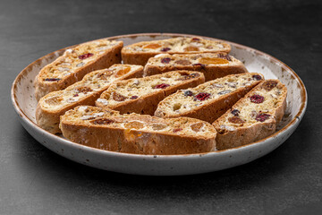 Italian Almond Biscotti biscuits in a rustic home made pottery bowl. Studded with almonds and...