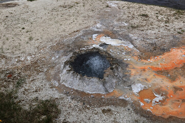 A boiling hot puddle from which a bright orange liquid flows out. The source is located in...