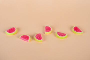 Fruit jelly mixed with sugar on cream background