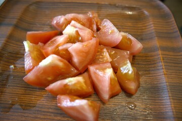 Sliced tomato on wooden tray