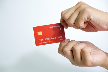 Close up of hand with red credit card isolated on white background. Shopping, finance and people concept