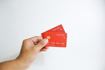 Close up of hand with red credit card isolated on white background. Shopping, finance and people concept