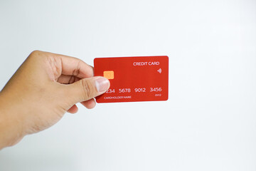 Close up of hand with red credit card isolated on white background. Shopping, finance and people concept