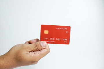 Close up of hand with red credit card isolated on white background. Shopping, finance and people concept