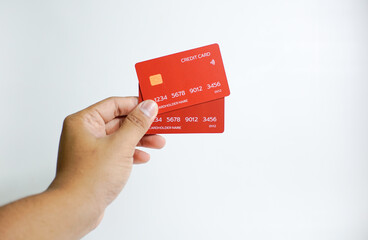 Close up of hand with red credit card isolated on white background. Shopping, finance and people concept