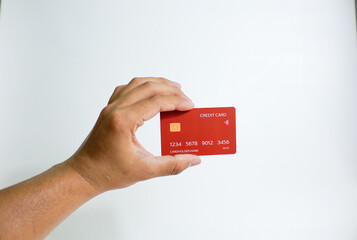 Close up of hand with red credit card isolated on white background. Shopping, finance and people concept