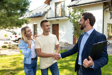 Real state agent talking to the clients after a successful deal
