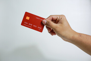 Close up of hand with red credit card isolated on white background. Shopping, finance and people concept