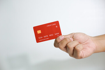 Close up of hand with red credit card isolated on white background. Shopping, finance and people...