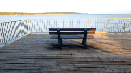 bench wood on sea beach coast front calm water protect by fence on wooden ponton atlantic coast