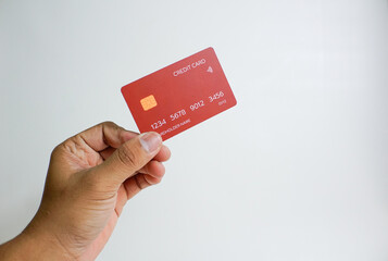 Close up of hand with red credit card isolated on white background. Shopping, finance and people...