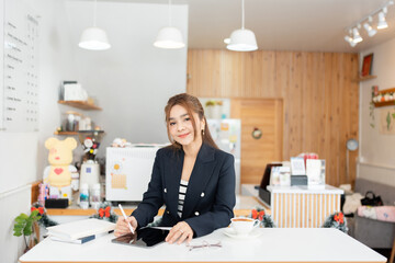 Within her office, the Asian female executive exemplifies a modern leader, using innovation to...