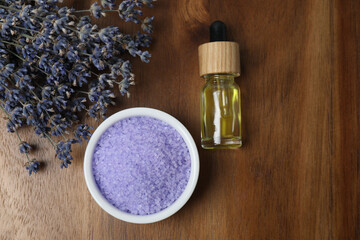 Lavender and lavender oil in bottles on wooden background
