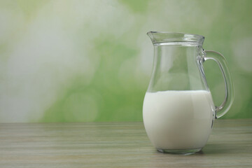 jug of milk, cornflakes on wooden background