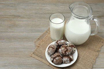 glass and jug with milk, cornflakes on wooden background