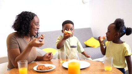 Loving mother nurturing children while sharing nutritious morning meal, creating warm connection during family breakfast in kitchen - Powered by Adobe