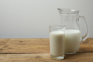 jug of milk, cornflakes on wooden background