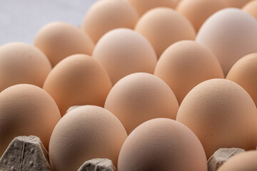 Brown eggs stacked in rows.Group of Fresh white Eggs in a cardboard cassette. Organic food from...