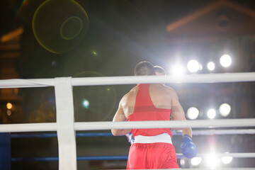 Boxing fight of two athletes in gloves in the ring