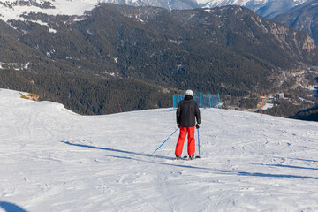 Skiers, snowboarders skiing in a mountain resort