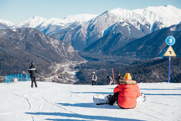Skiers, snowboarders skiing in a mountain ski