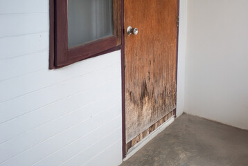 Improper use a plywood door for exterior is swollen and damaged by humidity in the rainy season.