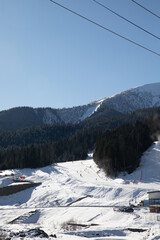 Snowboarders and skiers ski in the ski resort on the slopes