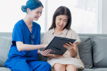 An elderly Asian woman visits the doctor and talks to the doctor about her illness in the clinic.