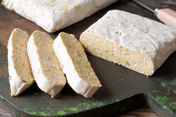 Traditional Fermented Tempeh Slices on Natural Background for Plant-Based Protein and Healthy Asian Food Concepts