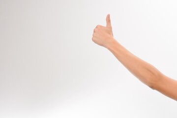 Thumbs up. Positive gesture against a clean white background. Perfect for expressing approval,...