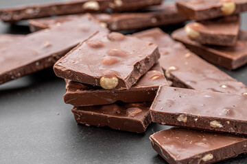 Chocolate cupcake with icing and chocolate bar in Dark lighting,Homemade delicious chocolate muffin on wooden background close-up